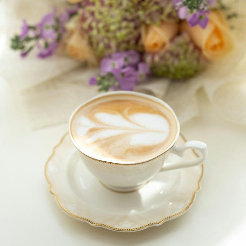 Bouquet Lying Next to Coffe Cup